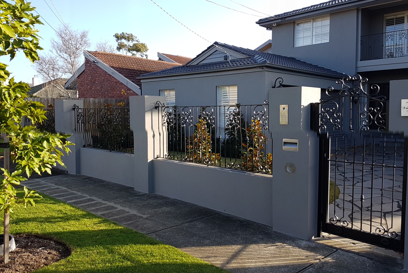 Rendered front boundary wall and decorative metal fencing in Essendon