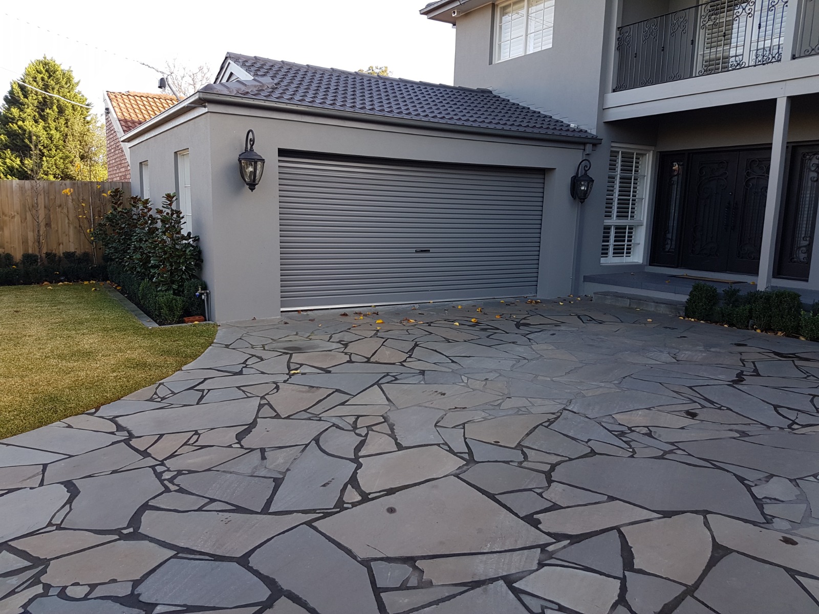 Rendered garage and exterior walls with textured finish beside a stone driveway in Essendon